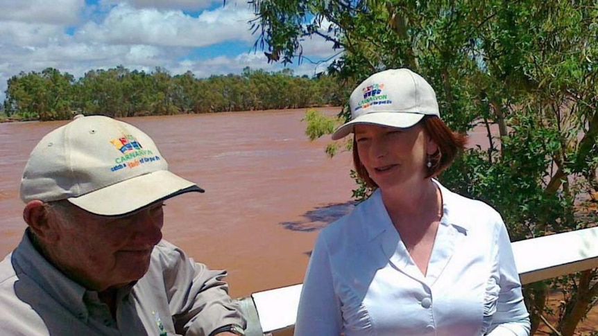 Julia Gillard chats to Tom Day, Carnarvon banana grower affected by floods, at the Nine Mile bridge