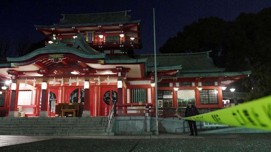 Policeman standing in front of shrine