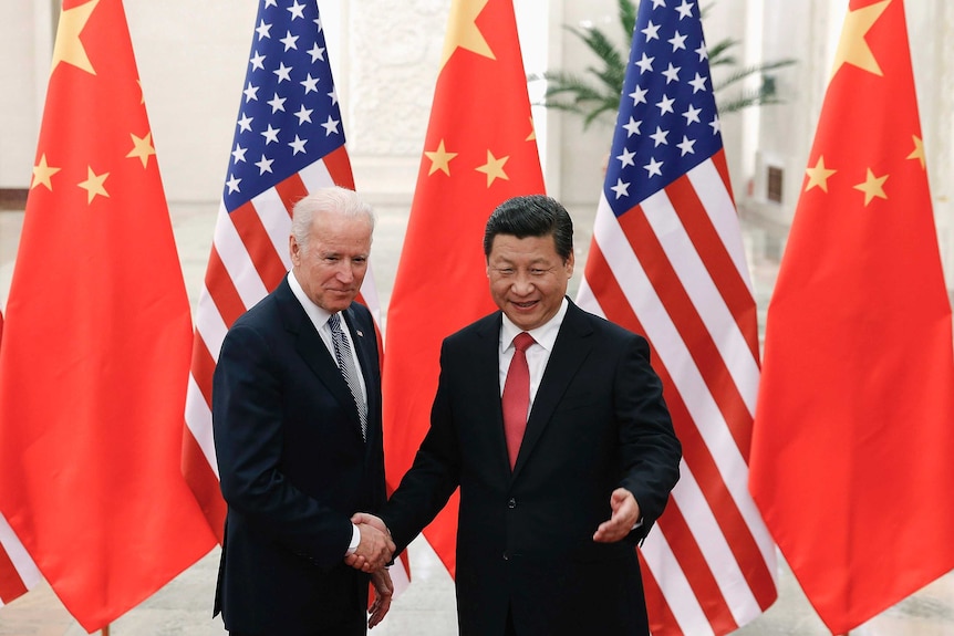 Chinese President Xi Jinping shakes hands with US Vice President Joe Biden inside the Great Hall of the People in Beijing