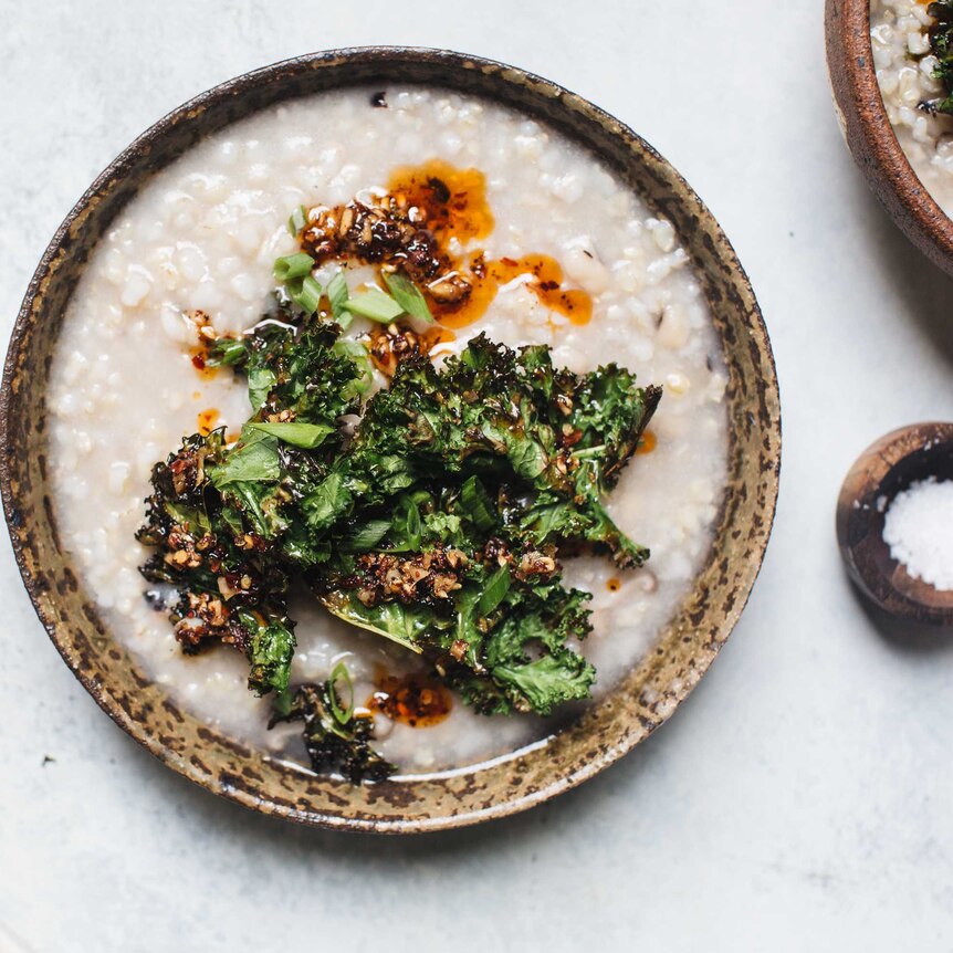 Three bowls of brown rice congee with a side of sea salt.