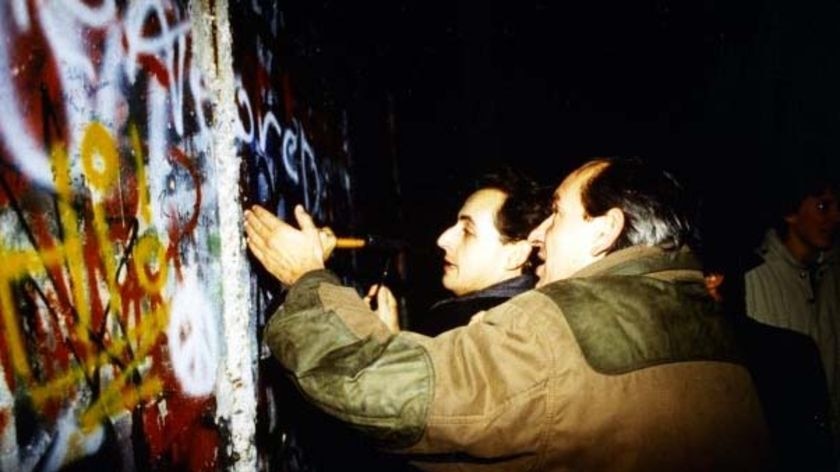 French President Nicolas Sarkozy at the Berlin wall