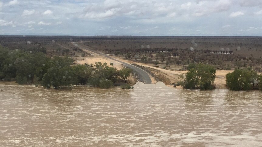 Flooded Cambridge Crossing closes sealed road at Richmond in north-west Queensland.