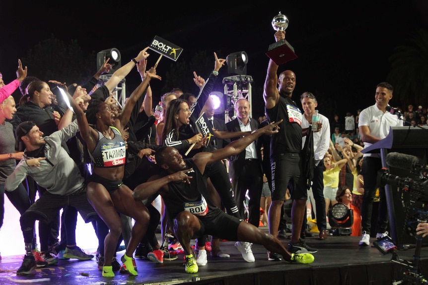 Usain Bolt holds the trophy after his All-Stars team wins Nitro Athletics title at Lakeside stadium.