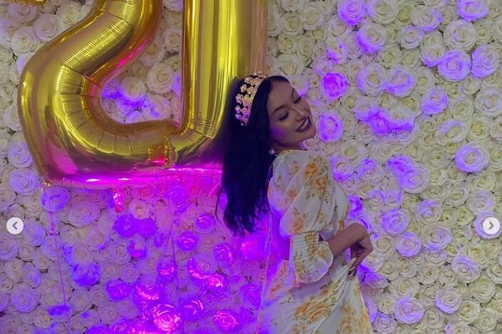 Ksenia Borodin celebrates her 21st birthday dressed up and with balloons and party decorations.