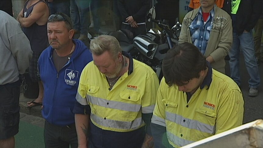 A minute's silence for the three killed when a wall collapsed on Swanston St in Carlton