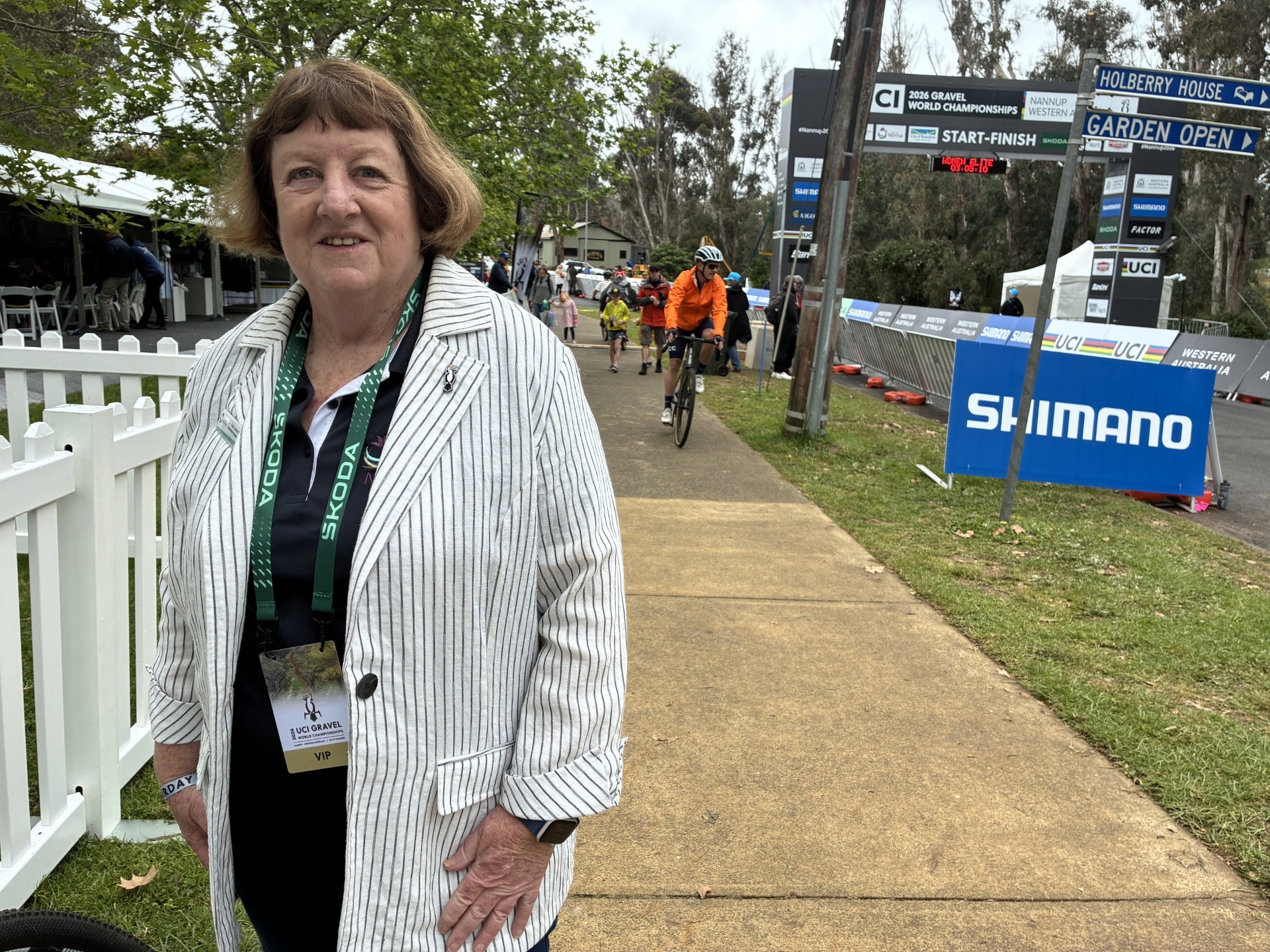 Vicki Hansen in Nannup with a cyclist in the background.