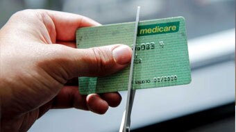 scissors cutting a medicare card