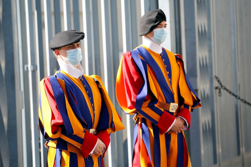 Members of the Swiss Guard wear face masks outside the Vatican.