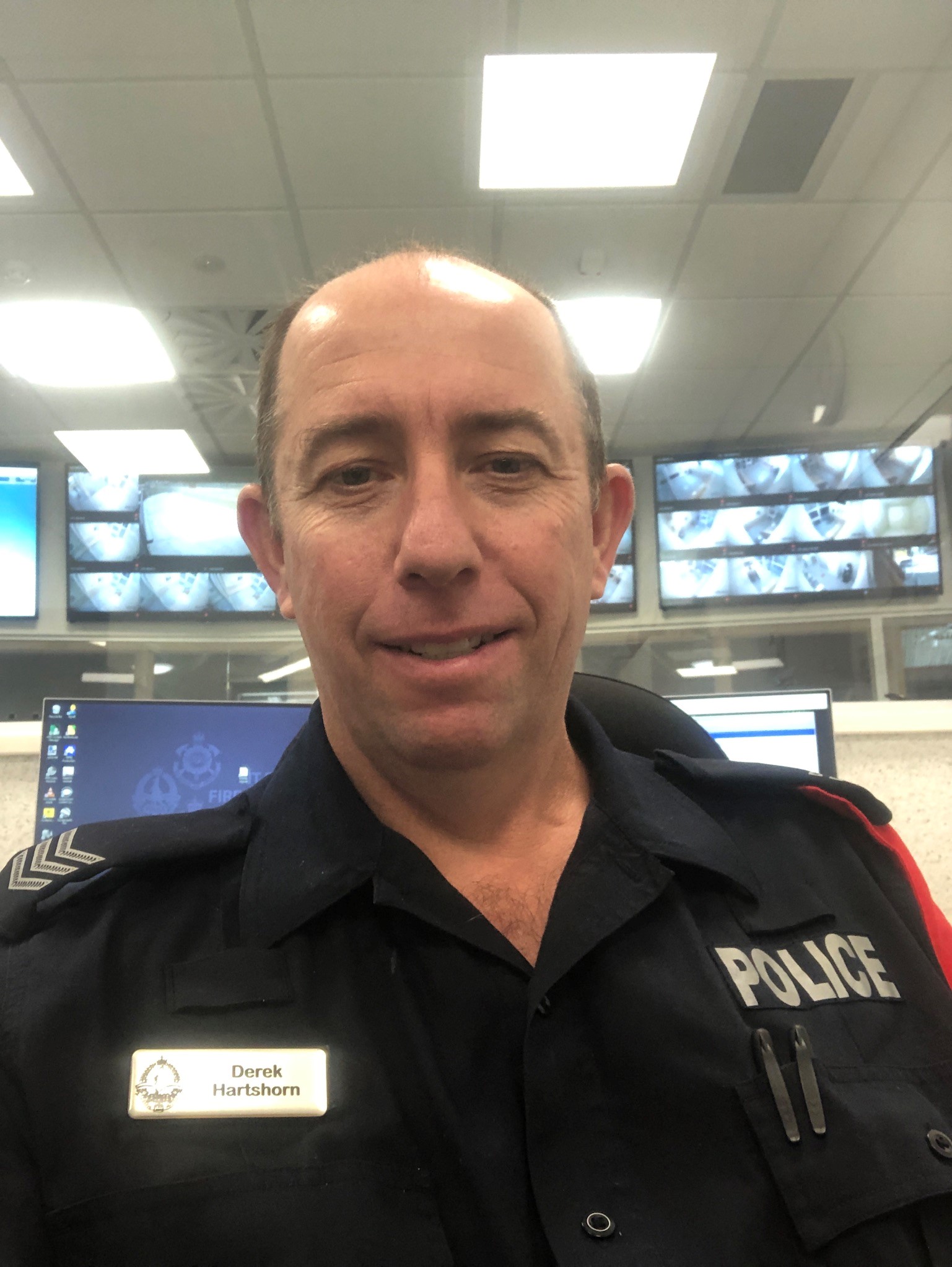 Former NT police sergeant Derek Hartshorn takes a selfie on duty inside a car.