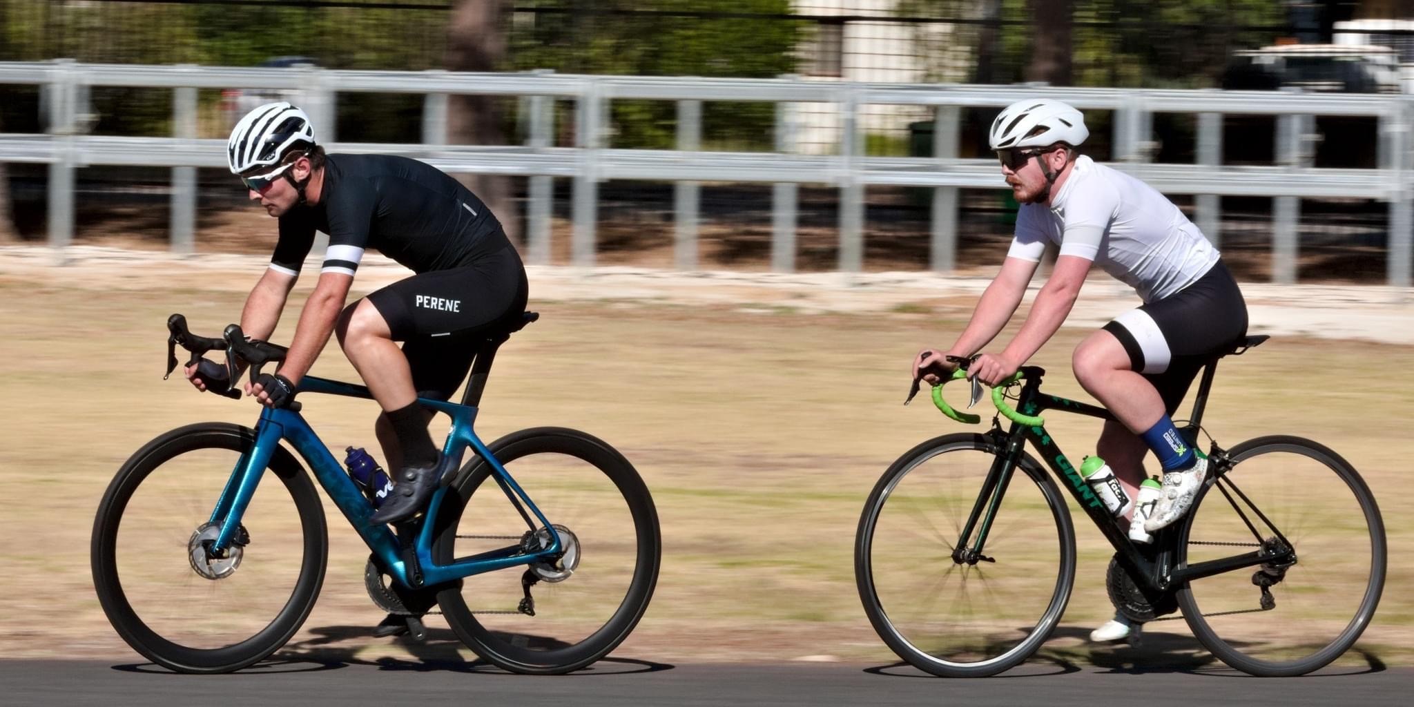 A pair of cyclists on a track during a race.
