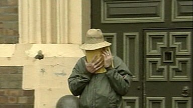 Freed: 'Mad Dog' Cox covers his face as he leaves jail