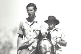Two men riding a horse in a black and white photograph at a station in WA