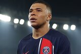  Kylian Mbappé walks off the field after a Champions League match for PSG.