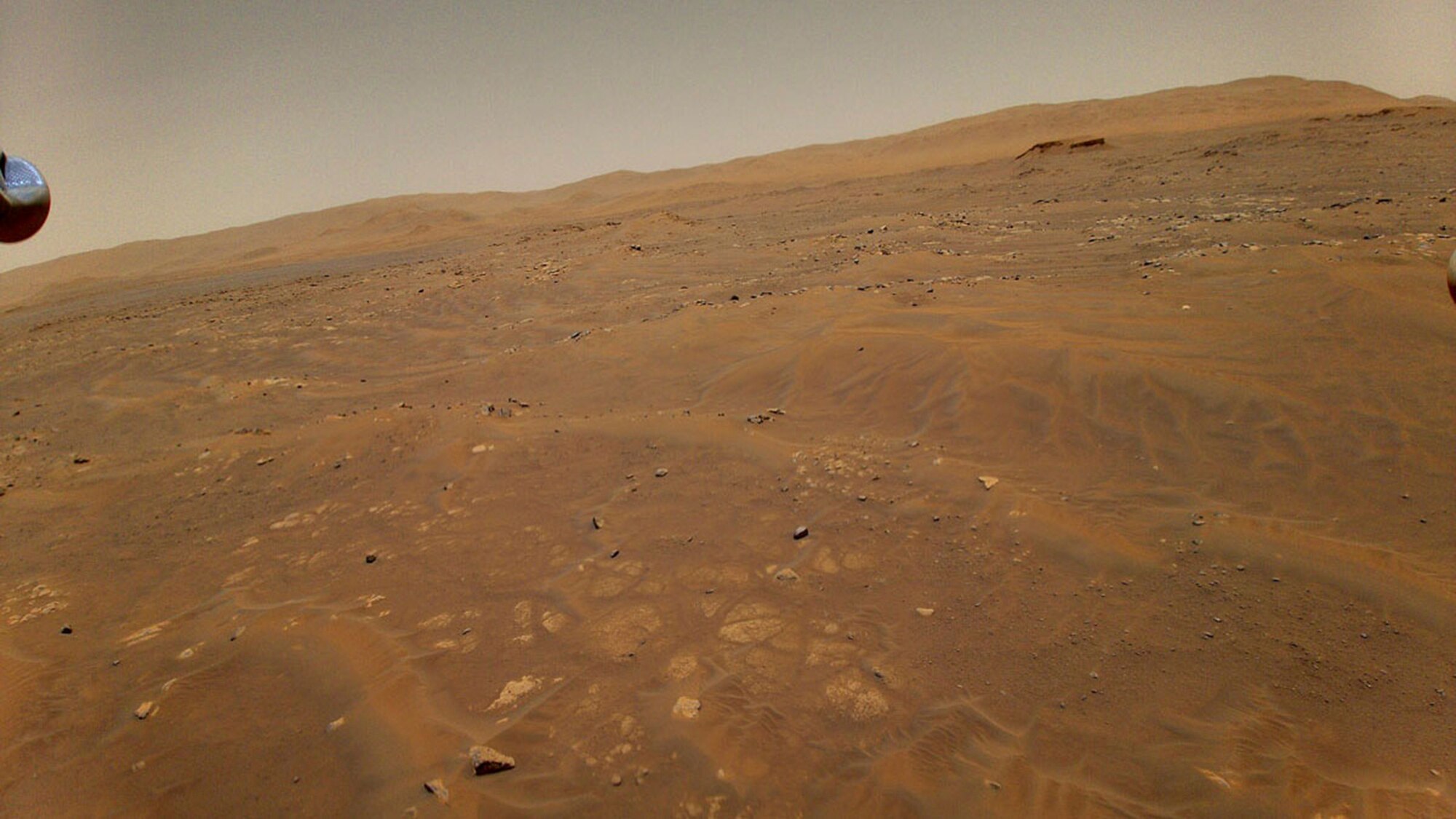 The barren landscape of Mars is shown from above