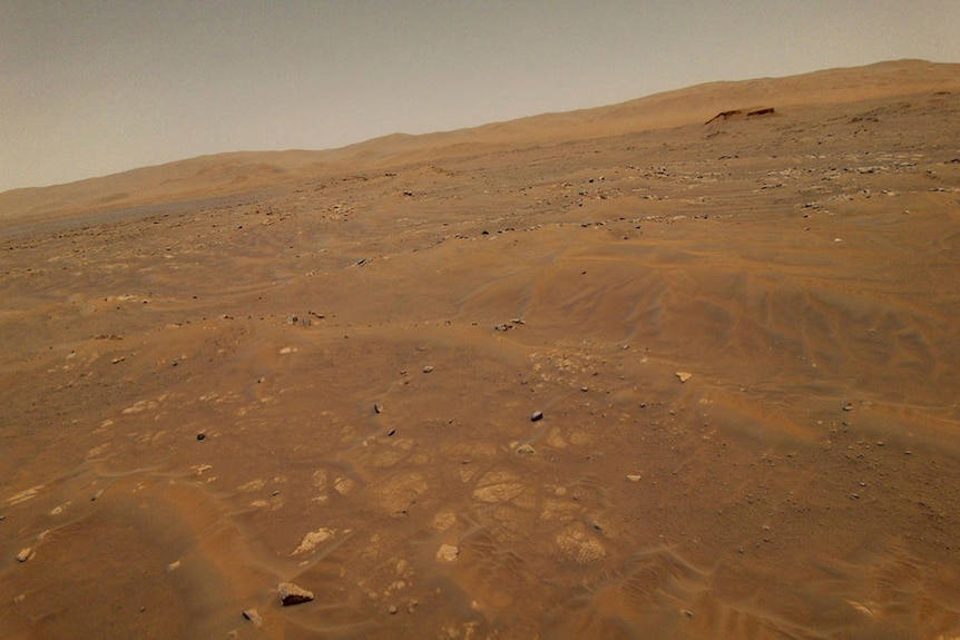 The barren landscape of Mars is shown from above