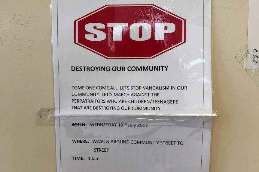 A flyer on a wall at a police station asking people help stop youth crime.