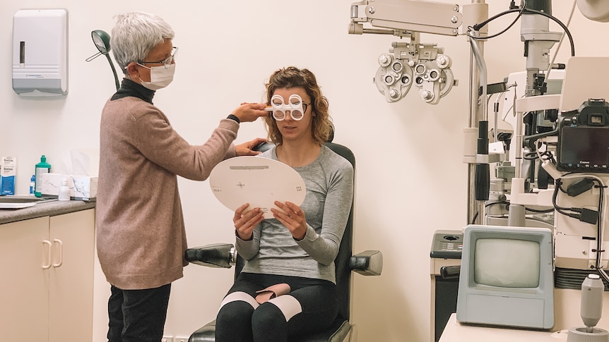 a woman is examined by an optometrist