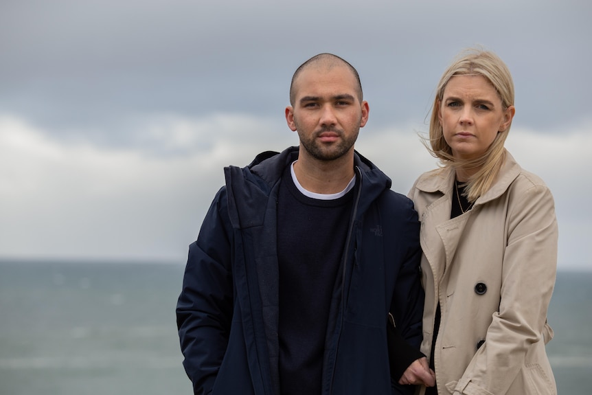 a man and woman looking sombre