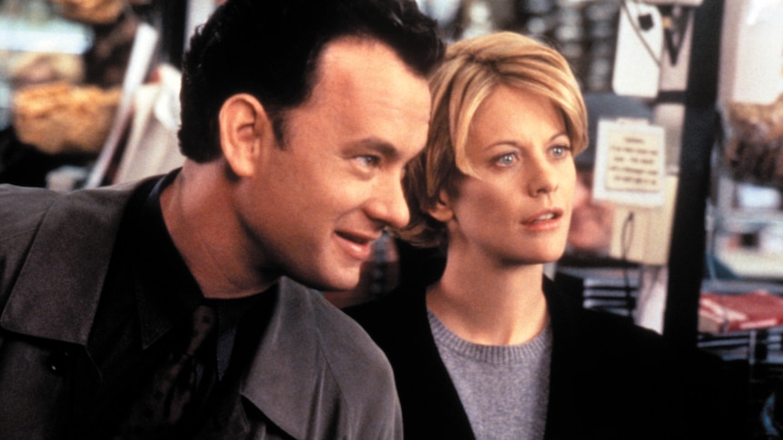 A screen still from the movie You've Got Mail, of Tom Hanks and Meg Ryan interacting in a bookshop.