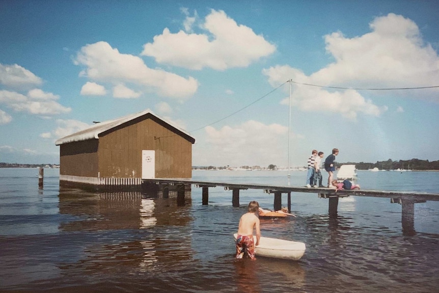 Kids play on the jetty of the Crawley Edge Boatshed in 1988