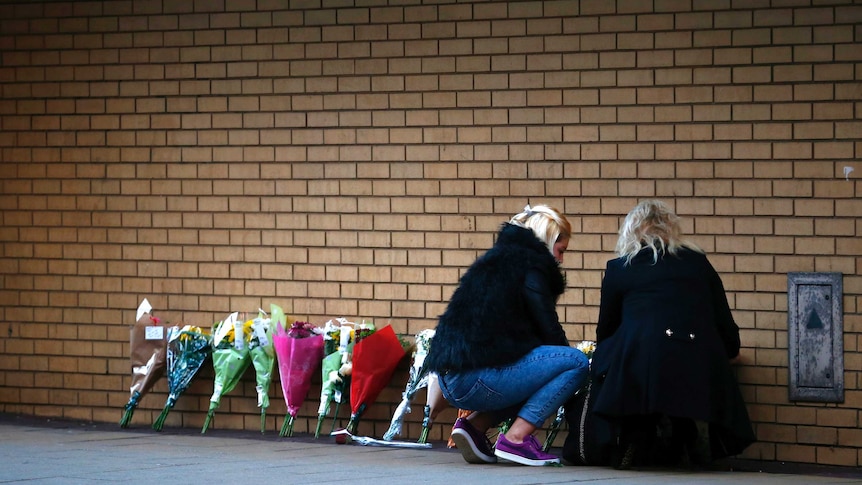 Women leave flowers near scene of Glasgow chopper crash