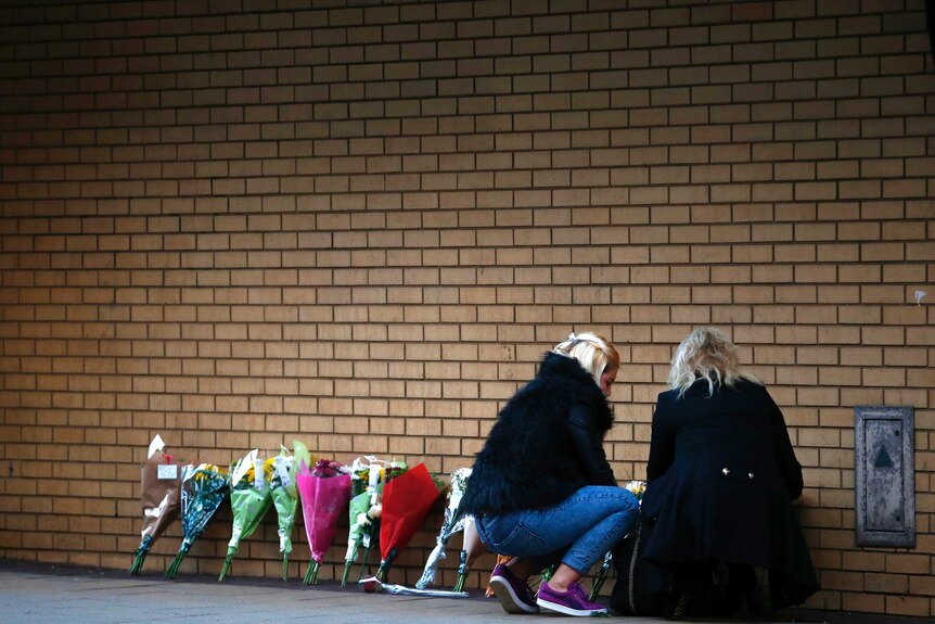 Women leave flowers near scene of Glasgow chopper crash
