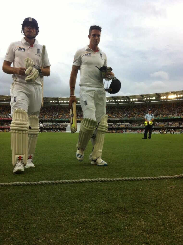 Alastair Cook and Kevin Pietersen walk off the Gabba pitch