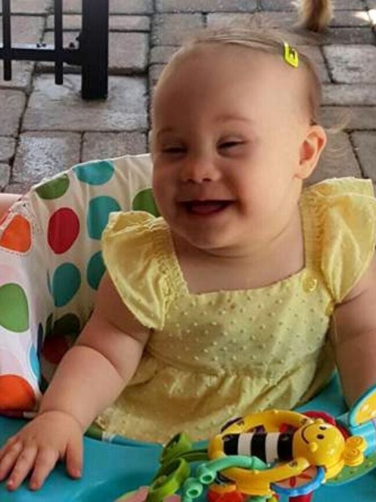 Willow Dunn smiling holding a toy.