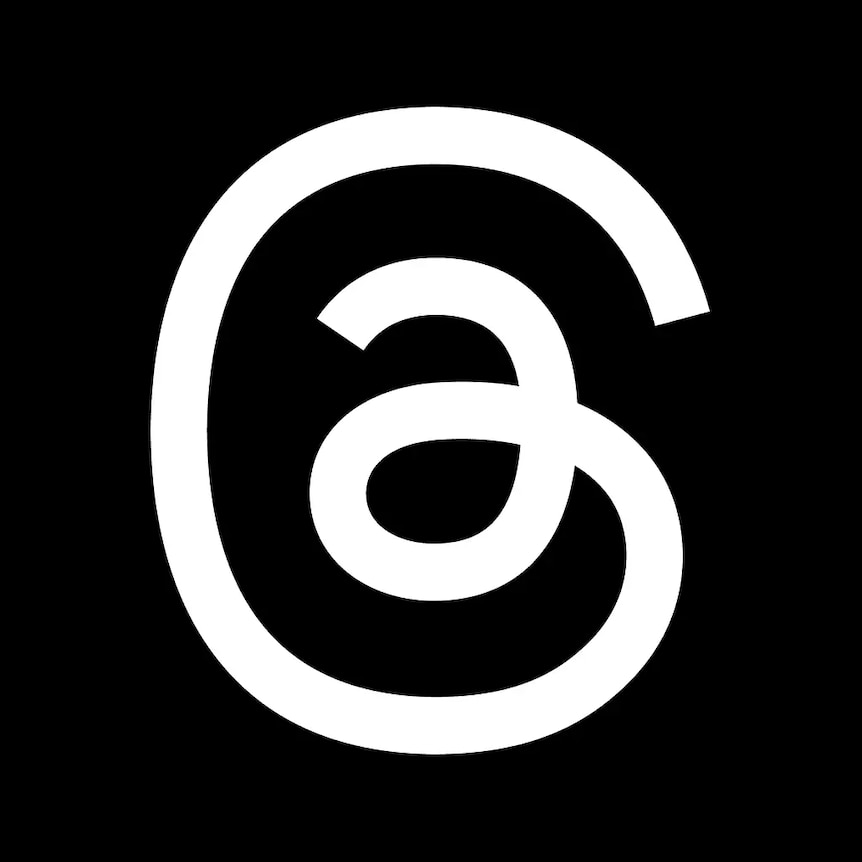 A black background with white squigly lines in the shape and of the at symbol