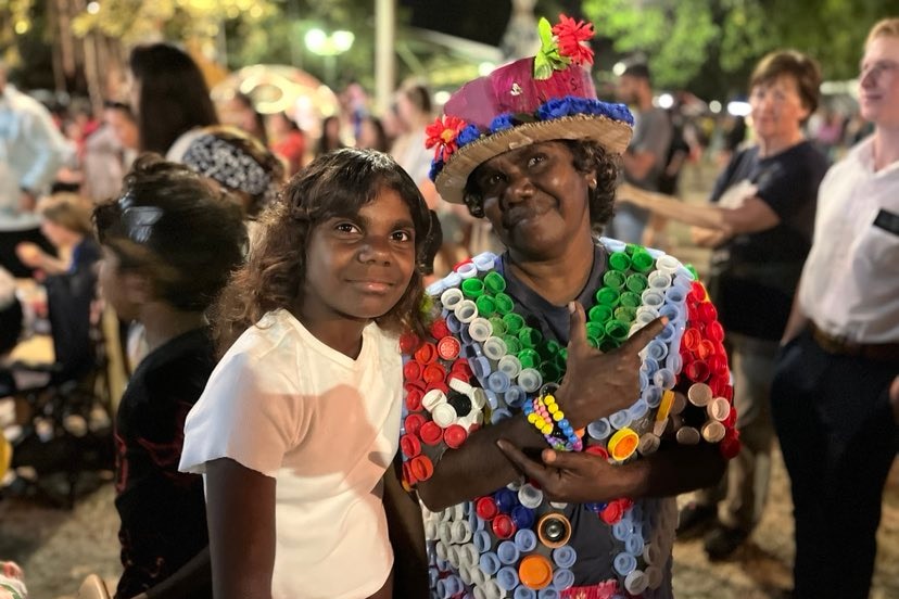 two aboriginal women at junk fest, with one wearing a colourful dress