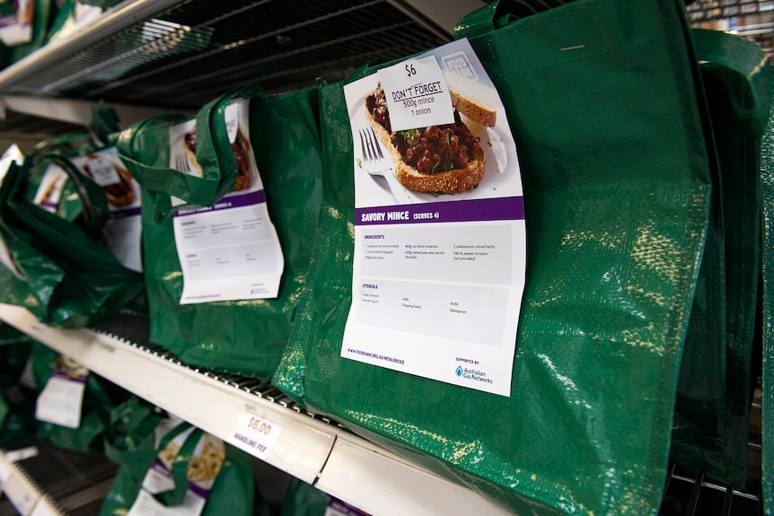 A shelf of green food packs