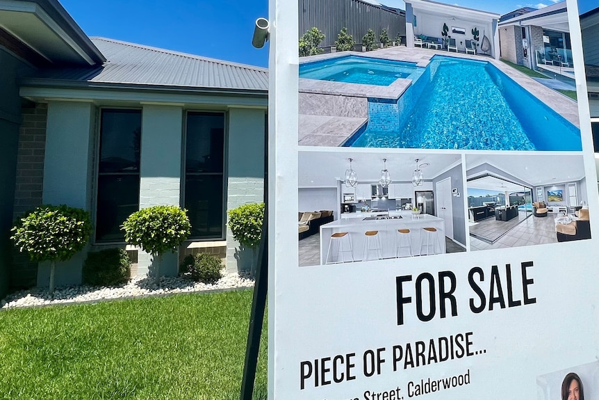 House for sale with a sign that says "piece of paradise".