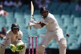 India batsman Cheteshwar Pujara is in his back swing for a powerful pull shot as Australia wicketkeeper Tim Paine watches on.