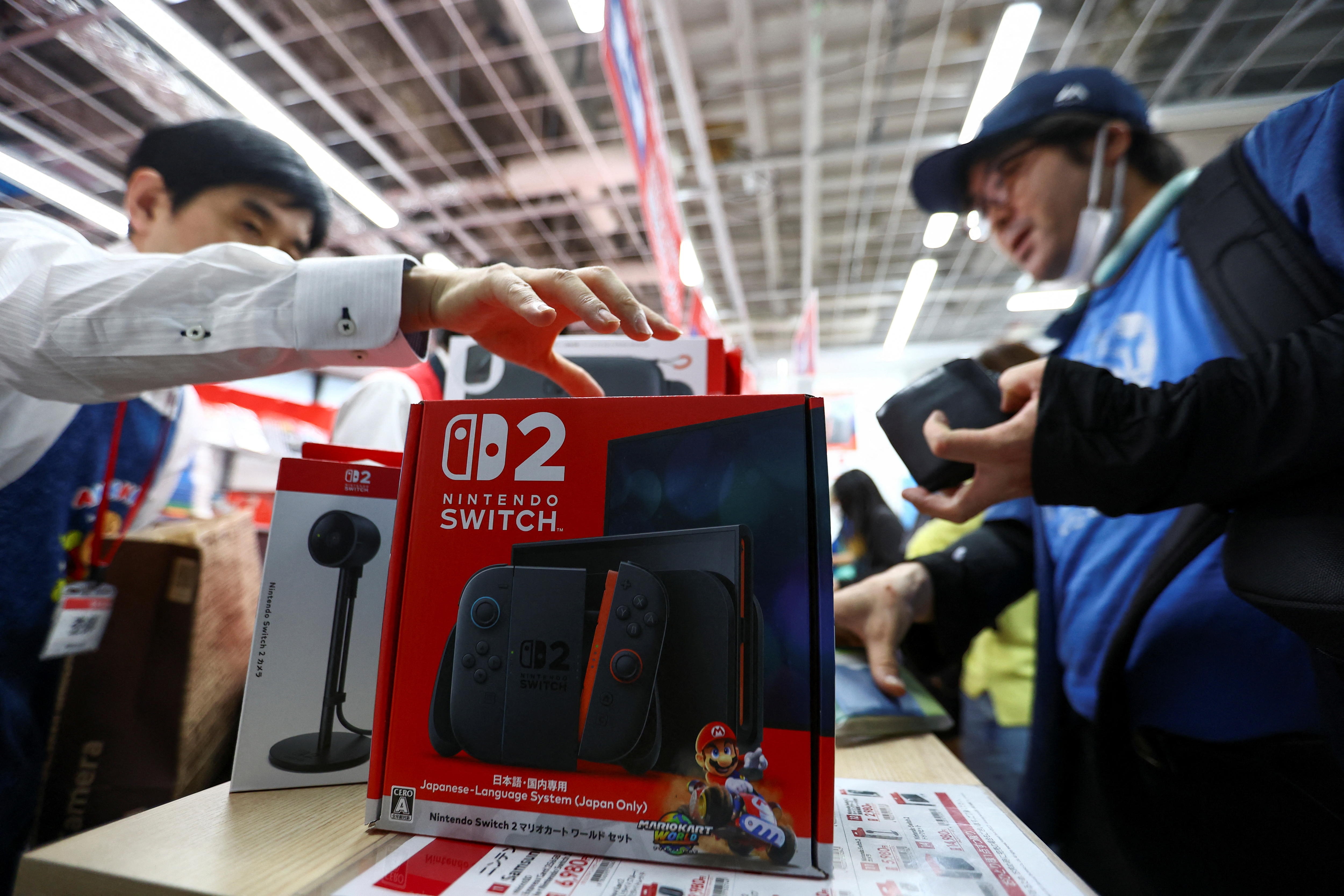 A cashier grabs a Nintendo Switch 2 box. 