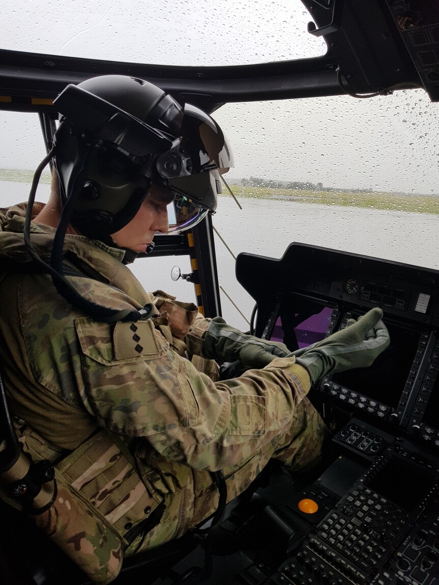 An Australian Army pilot sitting in a Taipan helicopter. 