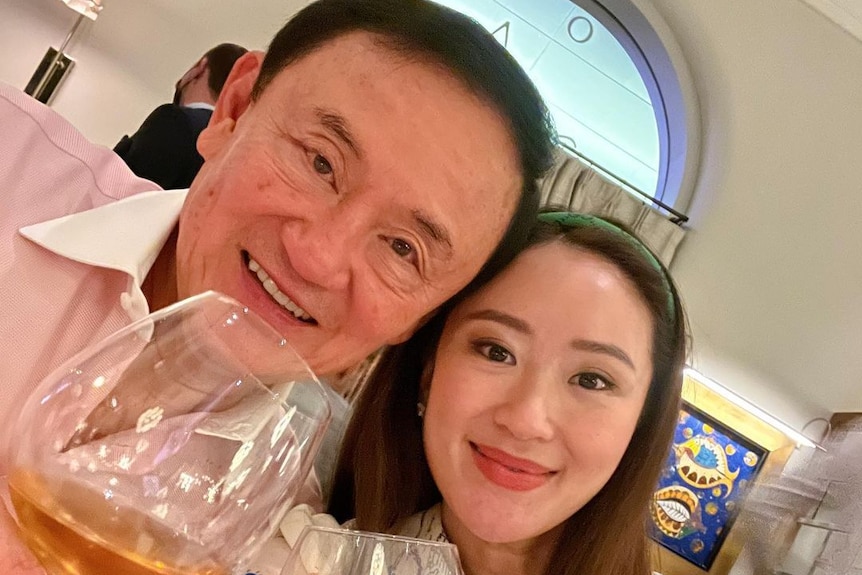 Thaksin and Paetongtarn Shinawatra pose for a selfie holding wine glasses