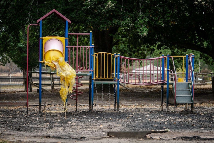 Playground in a park with a melted slide.