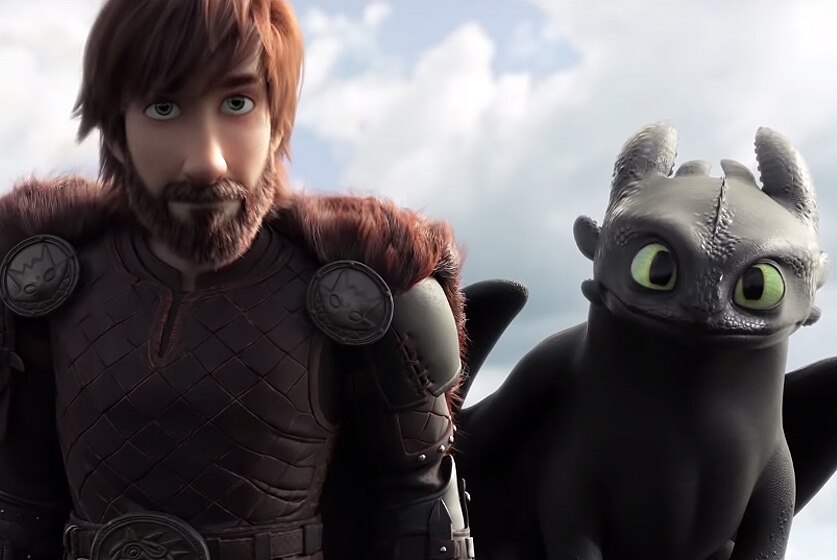 A man stands next to dragon in a screenshot from How To Train Your Dragon