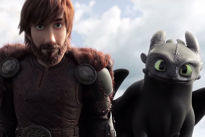 A man stands next to dragon in a screenshot from How To Train Your Dragon