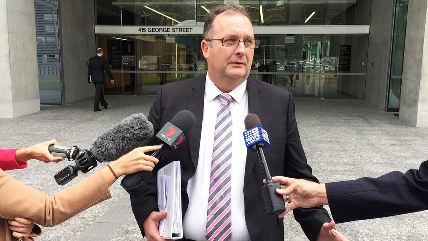 Lawyer Phil Rennick speaking outside court in Brisbane