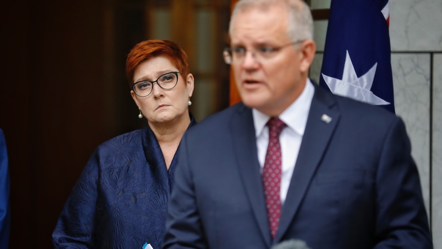 Marise Payne stands behind Scott Morrison at a press conference