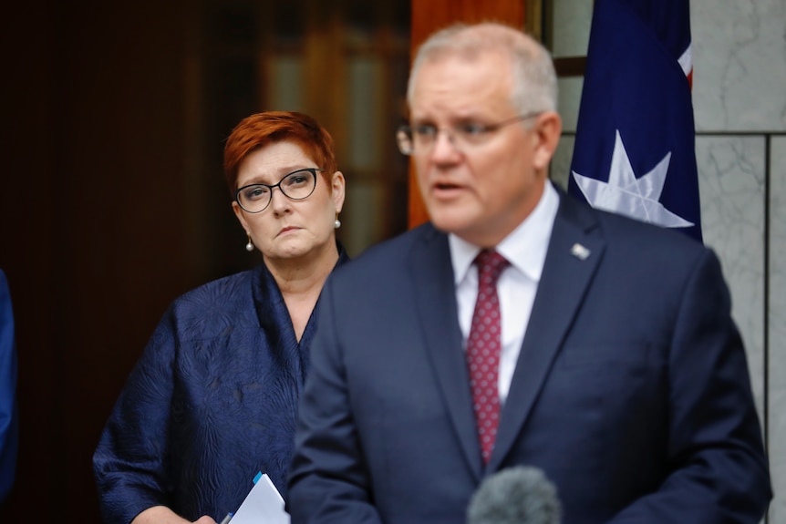 Marise Payne stands behind Scott Morrison at a press conference