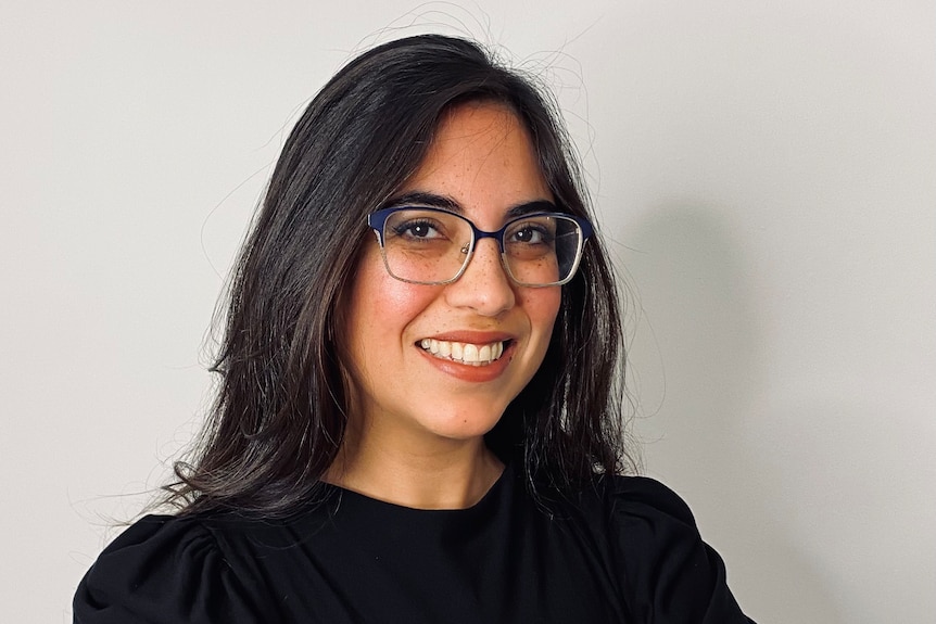 a headshot of Dr Tamar Krishnamurti wearing glasses and a black top 