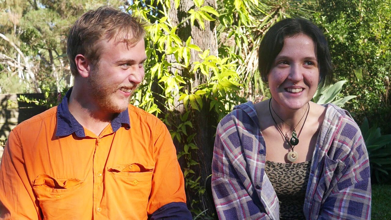 Leighton Fleming-Willmott and Anita Williamson sit together outside and smile.