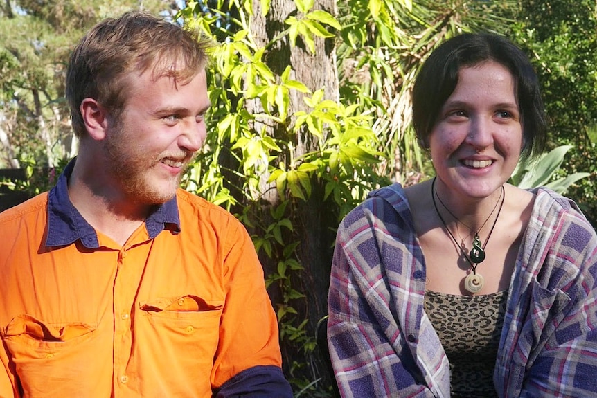 Leighton Fleming-Willmott and Anita Williamson sit together outside and smile.