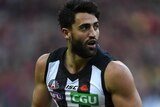 Alex Fasolo holds the football while playing against Essendon at the MCG.