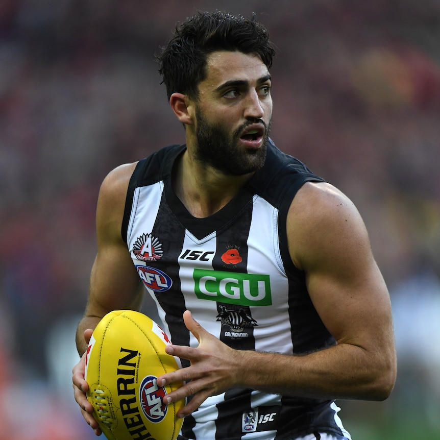 Alex Fasolo holds the football while playing against Essendon at the MCG.