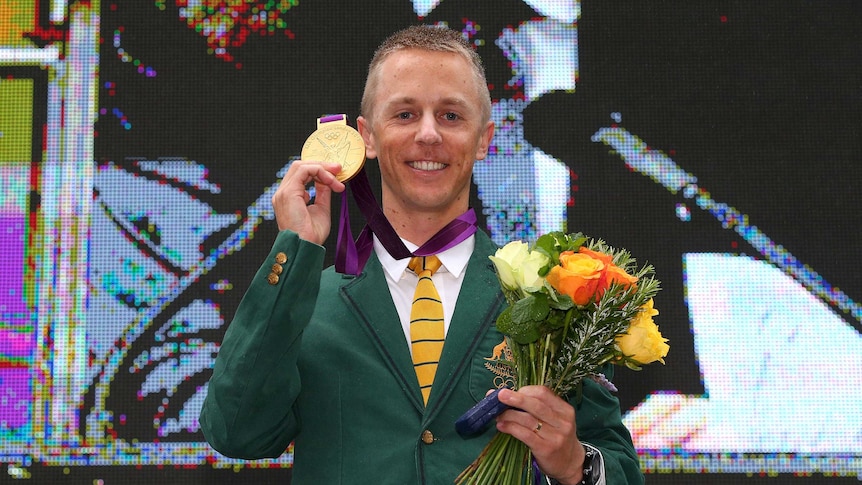 Australian athlete Jared Tallent poses with his Olympic gold medal in Melbourne on June 17, 2016.