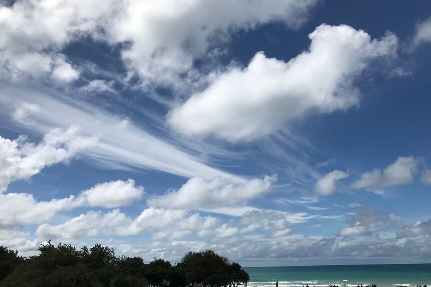 A cloudy sky over a beach.
