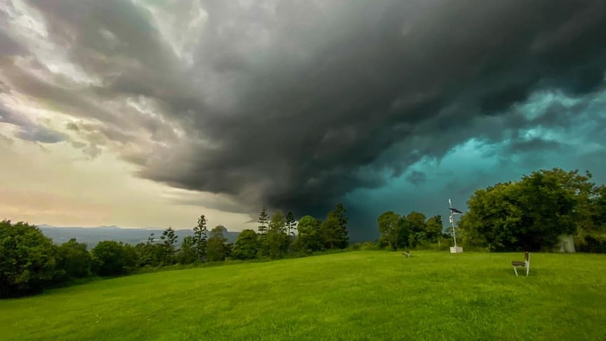 A black and green storm cloud in the distance